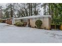 Ranch style home with red front door and snow covered lawn at 3426 Glensford Dr, Decatur, GA 30032