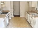 Kitchen with light cabinets, gas stove and built-in dishwasher at 3960 Brushy Wood Dr, Loganville, GA 30052