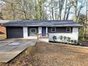 Charming single-story home with gray and white painted brick and a bright blue front door at 2371 Cresta Dr, Decatur, GA 30032