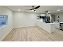 Open-concept living room flows into kitchen with light colored wood flooring at 2371 Cresta Dr, Decatur, GA 30032