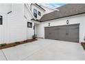 The home features a two-car garage with modern doors and exterior lighting at 515 Pearl St, Cumming, GA 30040