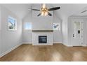 Spacious living area featuring hardwood floors, a fireplace, and large windows at 515 Pearl St, Cumming, GA 30040