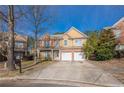 A two-story residence showcases a brick-and-siding exterior, a spacious driveway, and manicured landscaping under a clear sky at 1656 Hedington Ct, Lawrenceville, GA 30045