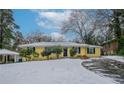 Yellow house with snow covered lawn at 3211 Sandusky Dr, Decatur, GA 30032