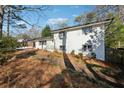 White brick home with large windows and mature trees at 3048 Charlbury Pl, Avondale Estates, GA 30002
