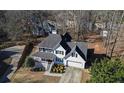 Two-story house aerial view showing a large backyard and surrounding trees at 198 Cypress Dr, Dallas, GA 30157