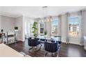 Open concept dining room with glass table and partial kitchen and bathroom views at 6146 Eves Way, Norcross, GA 30071