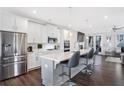 Modern kitchen with stainless steel appliances, white cabinets, and large island at 6146 Eves Way, Norcross, GA 30071