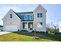 Two-story house with white brick and gray siding, featuring a front porch and attached two-car garage at 5435 Crestline View Rd, Cumming, GA 30028