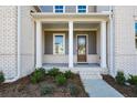 Covered front porch with white columns and a dark brown front door at 5435 Crestline View Rd, Cumming, GA 30028