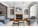 Comfortable living room featuring a fireplace, built-in shelves, and two chairs at 570 Parkside Village Nw Way # 12, Marietta, GA 30060