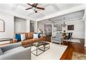 Open-concept living room with hardwood floors flowing into a dining area, great for entertaining at 570 Parkside Village Nw Way # 12, Marietta, GA 30060
