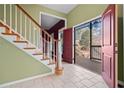 Two-story entryway with hardwood stairs and access to back deck at 7825 Brands Hatch Blvd, Cumming, GA 30040