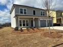 Beautiful two story home with a two-car garage, covered entryway and professional landscaping at 2112 Boxwood Se Cir, Conyers, GA 30094