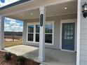 Close up of the front entrance featuring a covered porch, house number and a gray front door at 2112 Boxwood Se Cir, Conyers, GA 30094