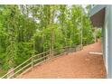 Landscaped backyard with wooden fence and wooded area at 9635 Haverhill Ln, Johns Creek, GA 30022