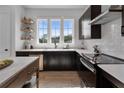Modern kitchen with dark cabinetry, white subway tile, and stainless steel appliances at 960 Bibbs Nw Cir # 2, Atlanta, GA 30318