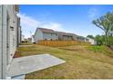 Wide open green grass backyard with wood fence in a row of houses at 711 Smokey Quartz Way, Kennesaw, GA 30144