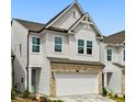 Attractive home featuring a two-car garage, crisp white siding, and a welcoming light-blue front door at 711 Smokey Quartz Way, Kennesaw, GA 30144