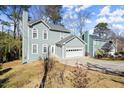 Two-story house with gray siding, white garage door, and a yard at 5689 Western Hills Dr, Norcross, GA 30071