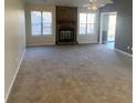 Spacious living room with a stone fireplace and carpet flooring at 1914 Grant Ln, Woodstock, GA 30188