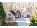 House nestled in a wooded area with a spacious yard at 7425 Ivy Grove St, Cumming, GA 30040