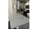 Bright kitchen boasts an island with a white countertop, complementing the white cabinetry at 215 Piedmont Ne Ave # 710, Atlanta, GA 30308