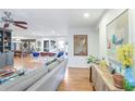 Bright living room featuring hardwood floors, a comfortable sofa, and large windows at 1389 Dogwood Se Cir, Smyrna, GA 30080