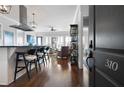 Entryway with dark door, hardwood floors, and kitchen view at 360 Chambers St # 310, Woodstock, GA 30188