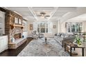 Charming living room with stone fireplace, built-in shelving, and views of the outdoors at 9475 Dunmoore Dr, Cumming, GA 30028