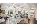 Bright and airy living room with coffered ceilings, hardwood floors, and fireplace at 9475 Dunmoore Dr, Cumming, GA 30028