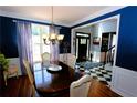 Elegant dining room with hardwood floors, chandelier, and view of entryway at 3854 Heritage Crest Pkwy, Buford, GA 30519