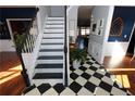 Elegant staircase with black and white risers and white railing at 3854 Heritage Crest Pkwy, Buford, GA 30519