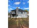 View of the home's back exterior featuring a deck and private backyard at 5619 Mayfair Crossing Dr, Lithonia, GA 30038