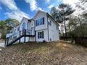 Side view of a two story home showcasing modern railing and backyard space at 5619 Mayfair Crossing Dr, Lithonia, GA 30038