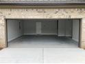 Spacious two-car garage with painted floor and ample space at 1534 Stargrass Dr, Grayson, GA 30017