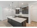 Modern kitchen with dark cabinetry, quartz countertops, and stainless steel appliances at 548 Sawnee Village Blvd # D72, Cumming, GA 30040