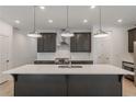 Modern kitchen with dark cabinetry, quartz countertops, and stainless steel appliances at 548 Sawnee Village Blvd # D72, Cumming, GA 30040