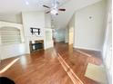 Living room with hardwood floors, fireplace, and high ceilings at 4140 Lanier Ridge Walk # 104, Cumming, GA 30041