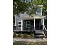 Two-story gray house with a front porch and steps at 935 Pelham Nw St, Atlanta, GA 30318
