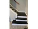 White and black staircase with tile floor at 201 Peyton Sw Pl, Atlanta, GA 30311