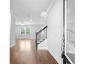Bright entryway with hardwood floors, staircase, and a view into the spacious living area at 1646 Tide Mill Rd, Cumming, GA 30040