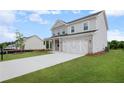 Beautiful two-story home with a spacious driveway, lush lawn, and attached two-car garage at 1646 Tide Mill Rd, Cumming, GA 30040