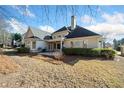 Back of house with patio, landscaping, and grassy yard at 2870 The Terraces Way, Dacula, GA 30019