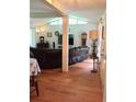 Open living room with hardwood floors, a large TV, and comfortable seating at 4625 Gaydon Rd, Powder Springs, GA 30127