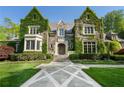 Beautiful stone home with ivy-covered walls and a meticulously landscaped front yard at 3685 Paces Ferry Nw Rd, Atlanta, GA 30327