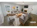 Virtually staged living room with gray sofas and a fireplace at 5431 Village Green Sq # 1018, Norcross, GA 30093