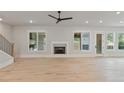 Bright living room featuring hardwood floors, fireplace, and access to backyard at 113 Creekview Ln, Canton, GA 30115