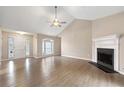 Bright living room boasting vaulted ceilings, a cozy fireplace, and large window at 2065 Arbor Forest Sw Dr, Marietta, GA 30064