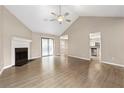 Open-concept living room featuring fireplace, vaulted ceilings, sliding doors, and seamless flow to kitchen at 2065 Arbor Forest Sw Dr, Marietta, GA 30064
